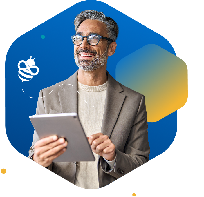 Smiling older man with gray hair and glasses holding a tablet, facing left on blue background