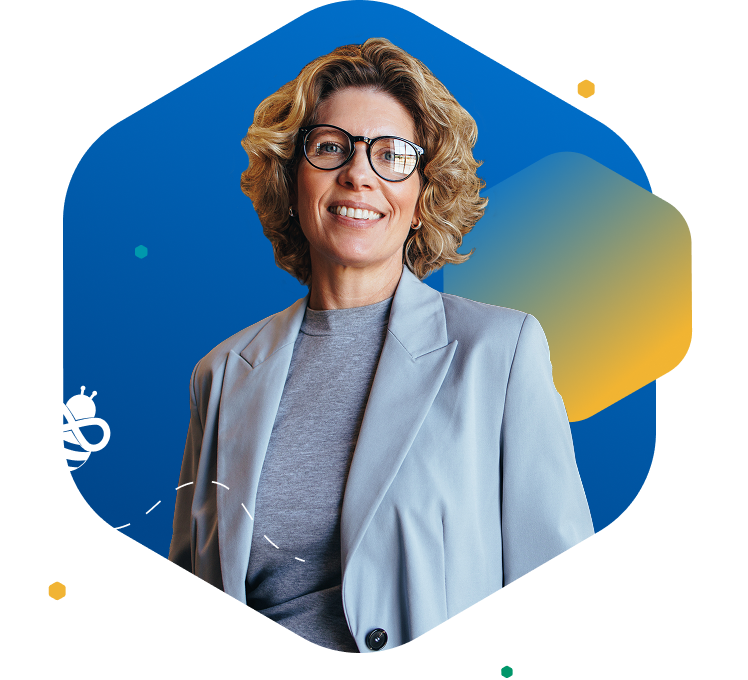 Smiling woman with short blonde hair and glasses facing left, wearing a blazer, in front of a blue background with colorful hexagon and bee icon